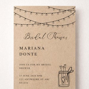 May include: A rustic bridal shower invitation with string lights and a mason jar illustration. The text reads "Bridal Shower," the names "Mariana Donte," and event details. The words "Buy, Edit, Download" are at the top.