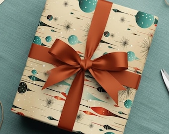 May include: A wrapped gift with a brown ribbon and bow, featuring beige paper with a teal and black pattern. Matching stickers and a teal cloth are present, along with scissors and twine.