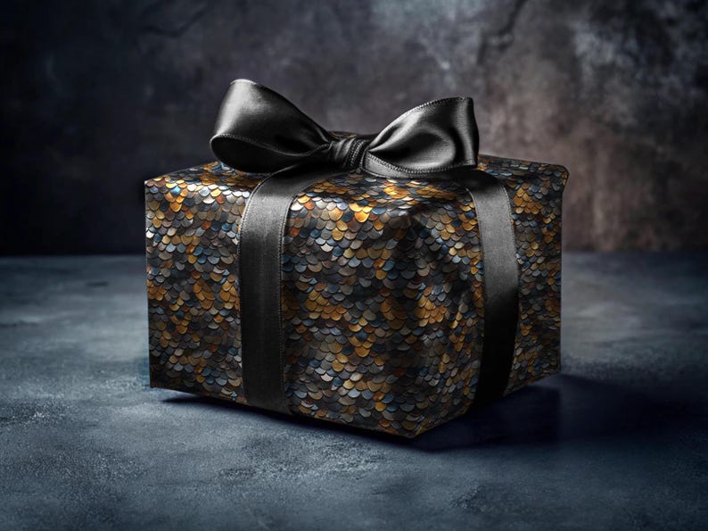 May include: A black gift box with a black satin ribbon bow. The box is wrapped in a patterned paper with a scale-like design in shades of gold, black, and blue.