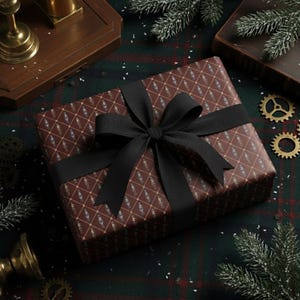 May include: A wrapped gift box with a brown patterned paper and a black ribbon. The gift box is on a green and red plaid surface, with decorative elements like gears and pine branches.