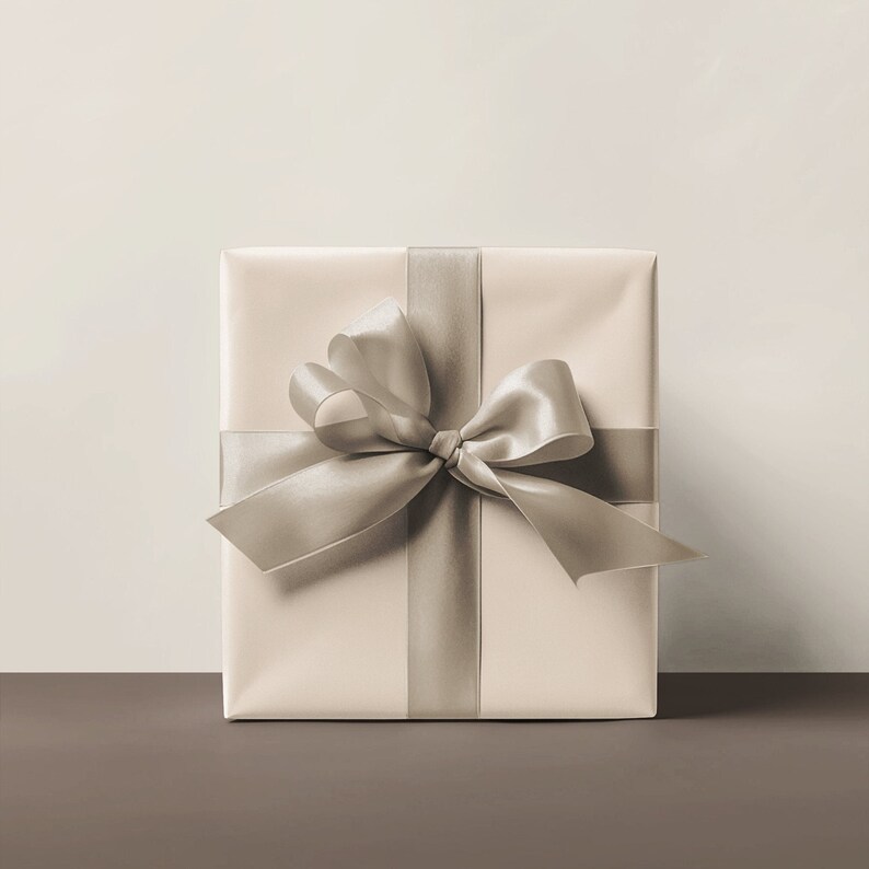 May include: A beige gift box with a large, silver satin bow.