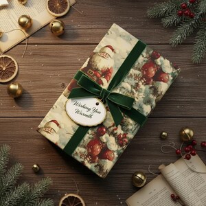May include: A wrapped gift box with a festive Christmas design featuring Santa Claus and red berries. The box is tied with a green velvet ribbon and a tag that reads "Wishing You Warmth". The background includes dried orange slices and gold bells.