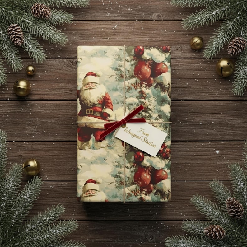 May include: A wrapped gift with a Santa Claus design, tied with a red velvet ribbon and a tag that reads "From Wrapped Studios." The gift is surrounded by pine branches, pine cones, and gold bells on a wooden surface, creating a festive holiday scene.