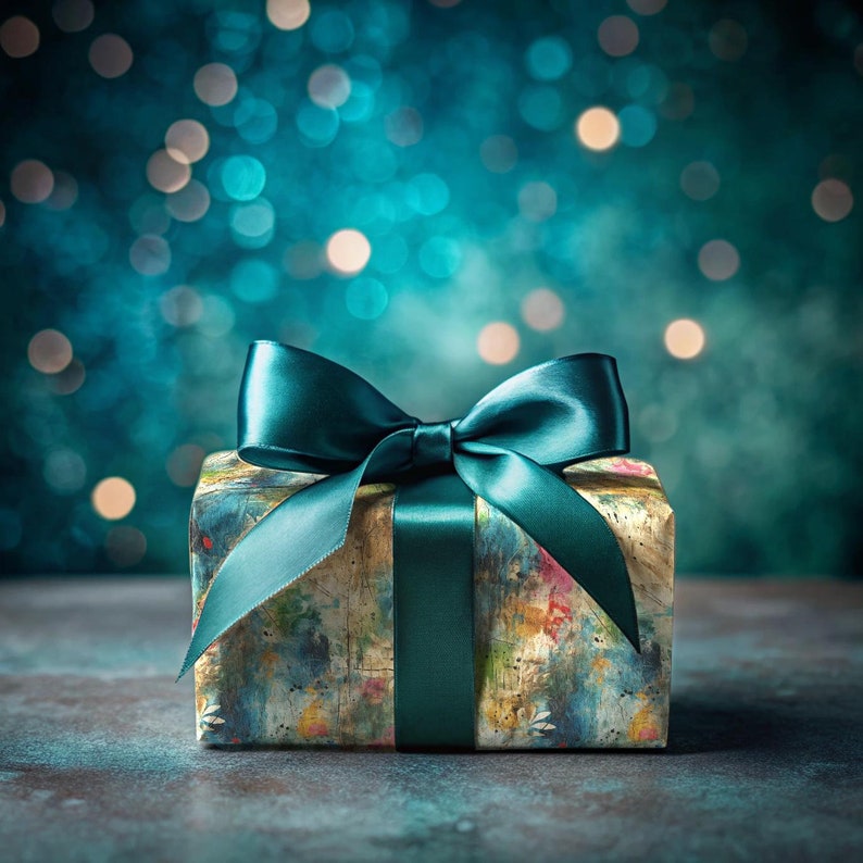 May include: A teal gift box with a teal satin ribbon bow. The box has a colorful abstract design and is sitting on a dark gray surface.