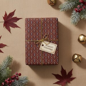 May include: A wrapped gift with a burgundy and blue pattern, tied with gold twine and a tag that reads "Season's Greetings." The gift is surrounded by seasonal decorations, including red leaves, pine branches, and gold bells.