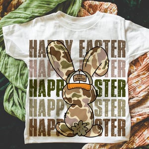 May include: White t-shirt featuring a camouflage bunny rabbit wearing a hat that says "Egg Hunter" and the words "Happy Easter" repeated in a distressed font.
