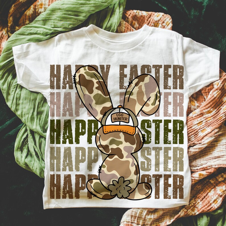 May include: White t-shirt featuring a camouflage bunny rabbit wearing a hat that says "Egg Hunter" and the words "Happy Easter" repeated in a distressed font.
