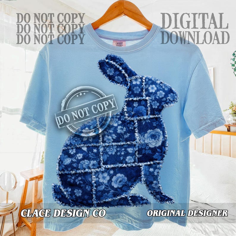 May include: A pale blue t-shirt with a patchwork rabbit design in various shades of blue and floral patterns. The shirt has the text "DIGITAL DOWNLOAD", "CLACE DESIGN CO", and "ORIGINAL DESIGNER".