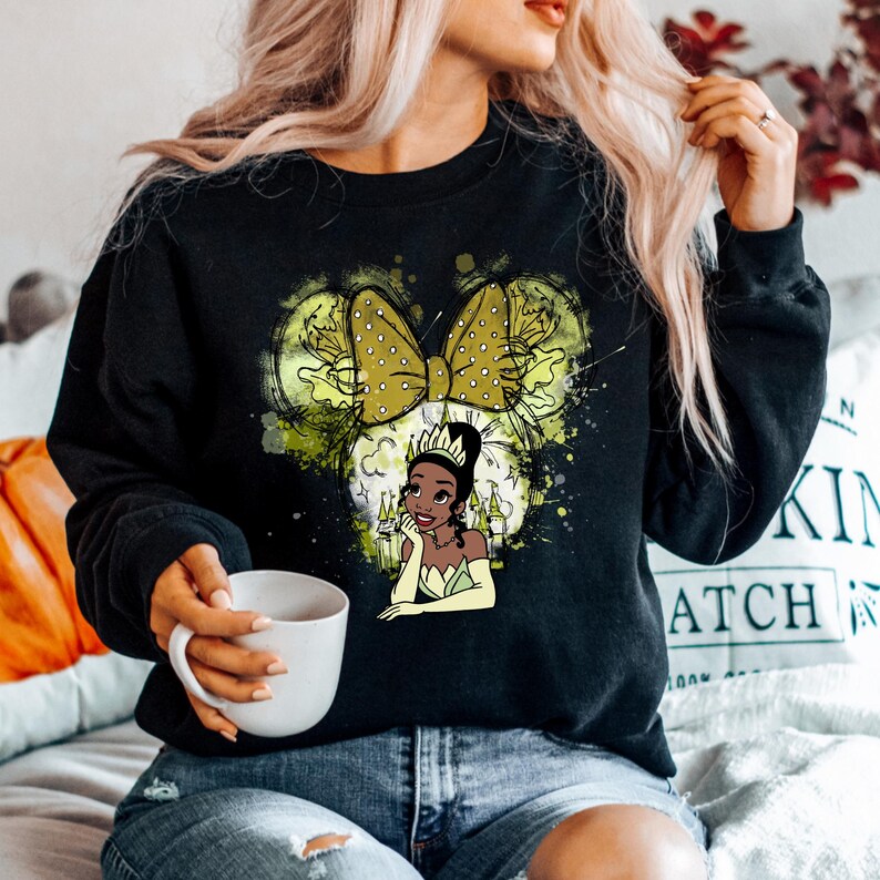 a woman sitting on a bed holding a cup of coffee