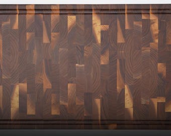May include: A rectangular end-grain wooden cutting board featuring a mosaic of dark brown and light tan wood blocks. The board has a deep, carved juice groove running along the entire perimeter of the surface, creating a distinct border.