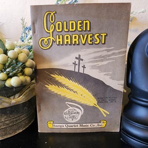 May include: A vintage booklet titled "Golden Harvest" with yellow lettering and wheat illustrations. The cover features a gray background with three crosses and the text "Sing Unto Him A New Song Psalms 33:3". Published by Stamps Quartet Music Co., Inc.