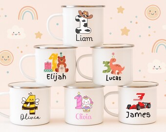 May include: White enamel mugs with silver rims, each featuring a unique design for a birthday. Designs include a cowboy-themed number one, a bear with gifts, a dinosaur, a bee, a unicorn, and a race car, each with a name.