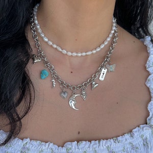 In this listing you can find 2 different necklaces. One freshwater pearl choker necklace and a unique silver charm necklace made with stainless steel chain and silver plated charm made from zamak or stainless steel.