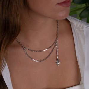 Unique DOUBLE LAYER silver necklace handmade in Greece.
This rock style choker- necklace has a unique arrow charm hanging from the one side, it is combined with the latest fashion trend.