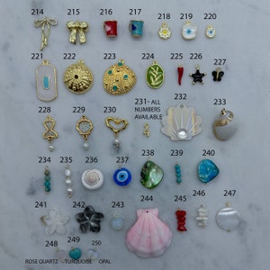 May include: Assortment of colourful charms for jewellery making, including seashells, butterflies, stars, flowers, and more. 231-ALL NUMBERS AVAILABLE.