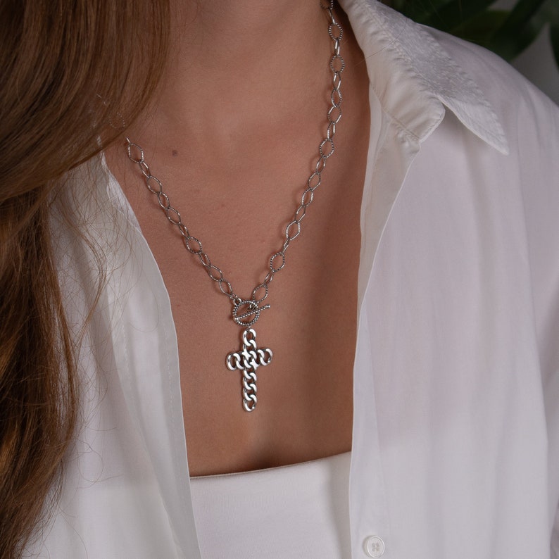 Unique Silver Cross Drop Necklace. The necklace has a toggle charm and a big cross pendant 40mm long is hanging from it. The pendant is made of silver plated zamak and the chain is 50cm long .The chain of the necklace is made of stainless steel