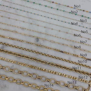 May include: A close-up of 14 different gold chains, numbered 1 through 14. The chains are arranged in rows, with the smallest chain at the top and the largest chain at the bottom.