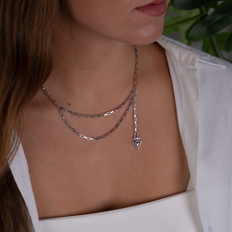Unique DOUBLE LAYER silver necklace handmade in Greece.
This rock style choker- necklace has a unique arrow charm hanging from the one side, it is combined with the latest fashion trend.