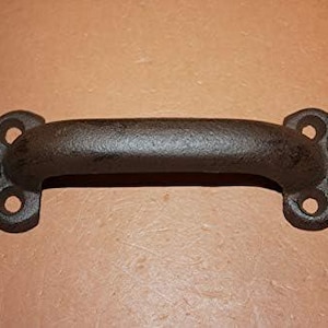 May include: A dark brown cast iron handle with a textured surface. The handle features two mounting plates on each end, each with two circular screw holes. The letters A and F are embossed on the left plate, and N and P are on the right plate.