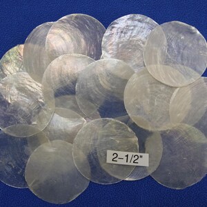 May include: A collection of 14 iridescent white mother of pearl shell discs, each measuring 2-1/2 inches in diameter.
