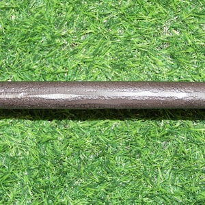 May include: A dark brown, textured metal door handle with a cylindrical center bar and rounded, decorative ends. Each end features a flat, circular mounting plate with two pre-drilled screw holes for installation on a door or cabinet surface.