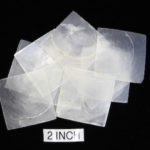May include: A pile of 2 inch iridescent white mother of pearl shell squares.