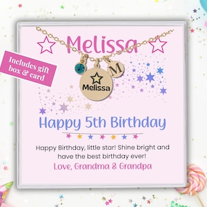 May include: A pink and white card with a gold necklace in a box. The card says "Melissa" and "Happy 5th Birthday". It also says "Happy Birthday, little star! Shine bright and have the best birthday ever! Love, Grandma & Grandpa".