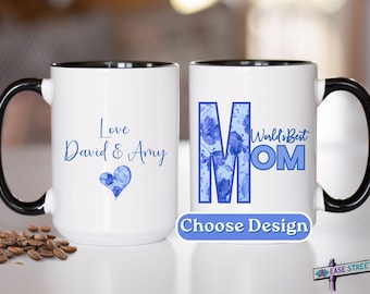 May include: Two white ceramic mugs with black handles. One mug has a blue floral design and the text "World's Best Mom". The other mug has the text "Love David & Amy" and a blue floral heart.