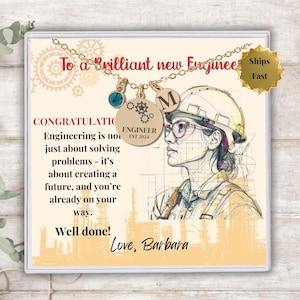 May include: A congratulatory card with a gold necklace and a charm that says "Engineer Est 2024". The card has a drawing of a woman wearing a hard hat and the text "To a Brilliant new Engineer. Engineering is not just about solving problems - it's about creating a future, and you're already on your way. Well done! Love, Barbara"