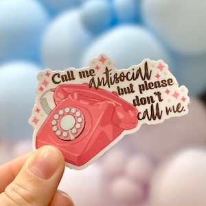 May include: A pink and white sticker with a red rotary phone and the text "Call me antisocial but please don't call me."