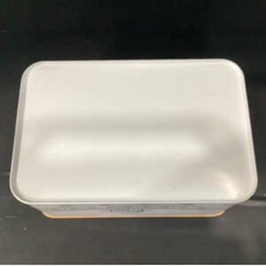 Top-down view of the closed white bread box against a dark background.