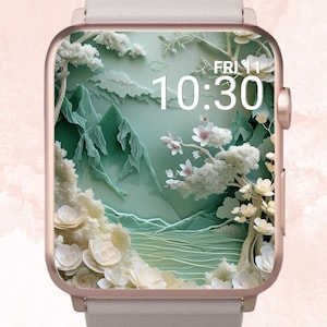 Könnte beinhalten: Eine roségoldene Smartwatch mit hellgrauem Armband zeigt ein Hintergrundbild zum Thema Natur. Der Bildschirm zeigt eine Landschaft mit Bergen, Bäumen und Blumen in Grün- und Weißtönen. Die Uhrzeit ist 10:30 Uhr, Freitag.