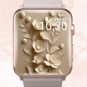 Könnte beinhalten: Eine roségoldene Smartwatch mit floralem Design auf dem Bildschirm. Das Zifferblatt zeigt weiße Blumen und Blätter vor beigem Hintergrund. Das Armband ist hellgrau, die Uhrzeit ist 10:30 Uhr am Freitag, dem 11. Der Text "Babe in Bloom CREATIONS" befindet sich oben.
