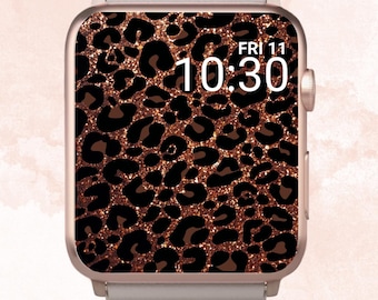 Könnte beinhalten: Eine roségoldene Apple Watch mit einem weißen Armband und einem Zifferblatt mit Leopardenmuster und goldenen Glitzer. Das Zifferblatt zeigt die Uhrzeit 10:30 und das Datum FRI 11.