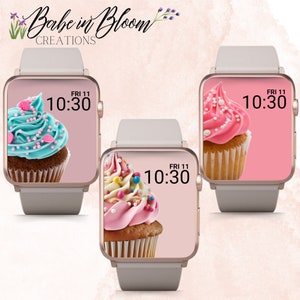 May include: Three Apple Watch faces with a pink background and a cupcake in the center. The cupcakes are decorated with pink, blue, and white frosting and sprinkles. The time is displayed as 10:30 with the day and date as FRI 11.