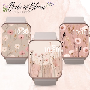 Op de afbeelding: Drie smartwatch-wijzerplaten met een bloemenontwerp. De wijzerplaten zijn allemaal roze en wit met een delicaat bloemenpatroon. De tijd wordt op elke wijzerplaat weergegeven als 10:30. De tekst "FRI 11" wordt ook op elke wijzerplaat weergegeven.