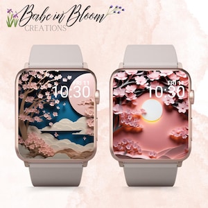 以下が含まれることがあります： ピンクゴールドのApple Watchの文字盤2つ。桜の紙切り細工がピンクと白でデザインされています。時間は10:30と表示されています。左側の文字盤は青い空、右側の文字盤はピンクの空です。
