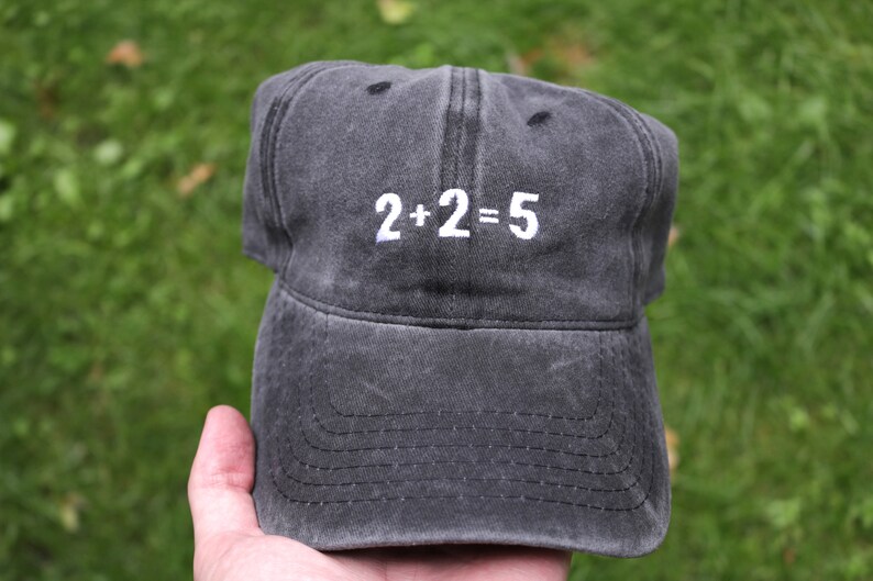 May include: A black baseball cap with white embroidery that reads "2+2=5".