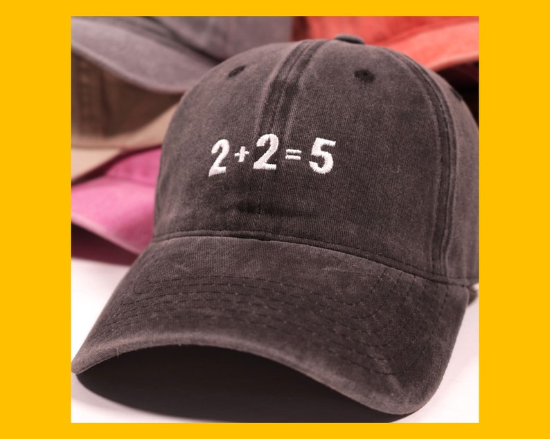 May include: A dark gray baseball cap with a white embroidered design that reads "2+2=5".
