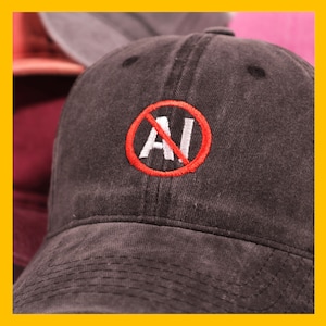 May include: A black baseball cap with a red circle and a white 'AI' with a diagonal line through it. The text 'No AI' is implied.
