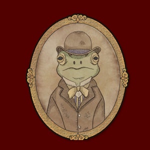 May include: A green frog wearing a brown suit and a black top hat with a purple band. The frog is in a gold oval frame with ornate details.