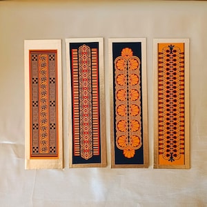 Inticate patterns in warm earthy colours and black, from Ancient Greek ceramics, adapted to create new designs. Bookmarks are rimmed with gold washi tape.