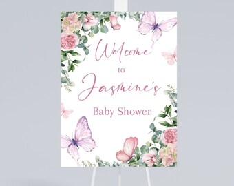 May include: Welcome to Jasmine's Baby Shower sign with a floral wreath and butterflies. The sign is on a white easel.