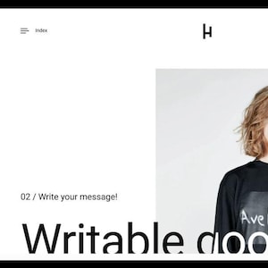 Könnte beinhalten: Ein Screenshot einer Website, die ein Schwarz-Weiß-Design für einen Online-Shop für Kleidung zeigt. Die Website zeigt ein Model, das ein schwarzes Sweatshirt mit dem Text "Ave Mari" trägt. Die Website zeigt auch ein Mobiltelefon, das ein ähnliches Design anzeigt.