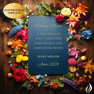 May include: A blue card with gold lettering announcing a baby is coming soon in June 2024. The card is surrounded by colorful dried flowers on a wooden surface.