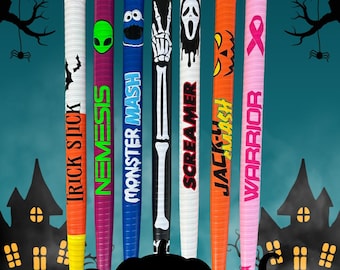 May include: A collection of seven colorful Halloween-themed bats. Each bat features a unique design, including a ghost, alien, and skeleton hand. The bats are arranged in front of a teal background with silhouettes of a haunted house, trees, and jack-o'-lanterns.