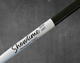 May include: A black and white Sharpie marker with the words "Showtime", "Permanent Flight", and "Moon Shot" printed on the barrel. The marker has a white barrel with black text and a black tip.