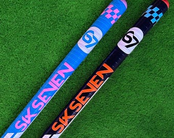 May include: Two hockey sticks with the text "SIX SEVEN". One stick is blue with pink and white accents, the other is black with orange and white accents. Both sticks have a checkered pattern at the top.