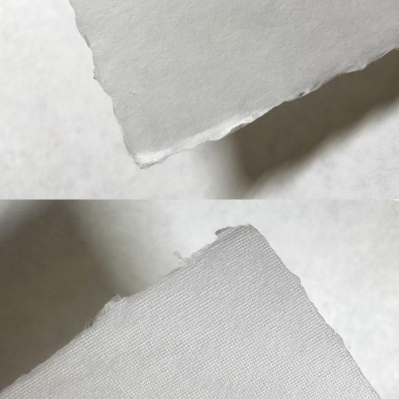 Puede incluir: Primer plano de dos trozos de papel blanco con bordes rasgados. El papel tiene una superficie texturizada y un color ligeramente blanquecino. Los bordes son &aacute;speros e irregulares, lo que sugiere una calidad artesanal.