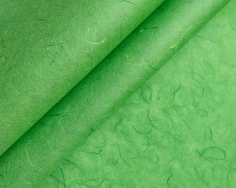 May include: Green textured paper with a crinkled, wrinkled, and folded appearance. The paper has a subtle, light green color.